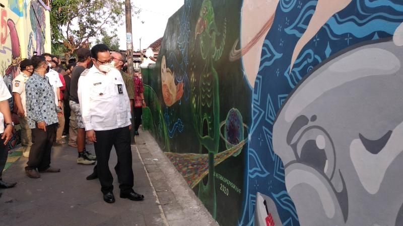 Wakil Walikota Yogyakarta, Heroe Poerwadi, menyaksikan sejumlah hasil mural seniman dan warga yang melukis di Gang Mural Kampung Taman RT 31, 33/ RW 08, Kelurahan Patehan, Kecamatan Kraton, Kota Yogyakarta, Rabu (23/9/2020). [Muhammad Ilham Baktora / SuaraJogja.id]