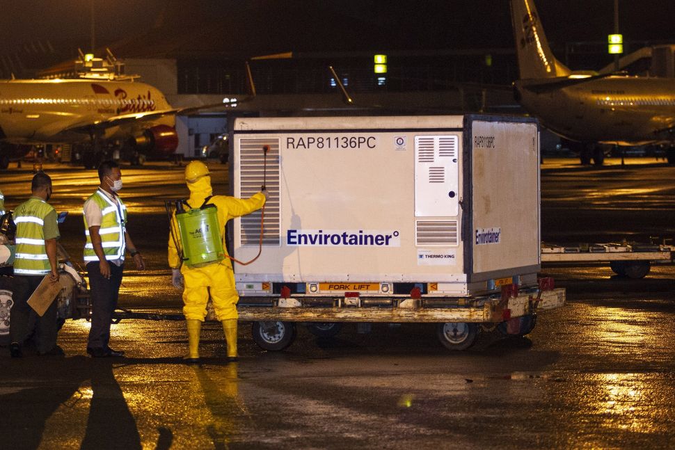 Petugas menyemprotkan disinfektan ke kontainer berisi vaksin COVID-19 saat tiba di Bandara Soekarno-Hatta, tangerang, Banten, Minggu (6/12/2020). [ANTARA FOTO/Dhemas Reviyanto]