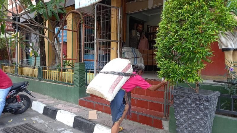 Buruh gendong Pasar Beringharjo saat mengangkat beban dagangan Senin (26/4/2021). [Mutiara Rizka M / SuaraJogja.id]