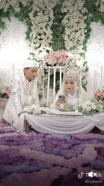 Viral pengantin wanita ujian online di meja akad setelah akad nikah. Aksi pengantin perempuan itu ditonton 19 juta kali.