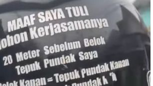 Tulisan dibagian belakang helm pengemudi ojol tunarungu. (Sumber: Instagram)