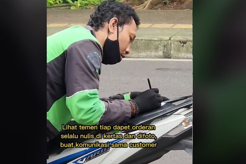 Driver ojol ini komunikasi dengan customernya pakai tulisan di kertas dan difoto karena ponselnya rusak. [TikTok]