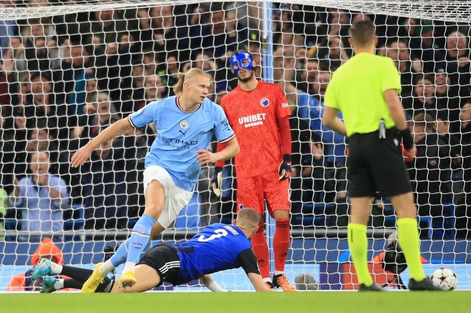 Striker Manchester City asal Norwegia, Erling Haaland melakukan selebrasi setelah mencetak gol pertama timnya selama matchday ketiga Grup G Liga Champions antara Manchester City vs Kopenhagen di Stadion Etihad di Manchester, barat laut Inggris pada 5 Oktober 2022.Lindsey Parnaby / AFP.