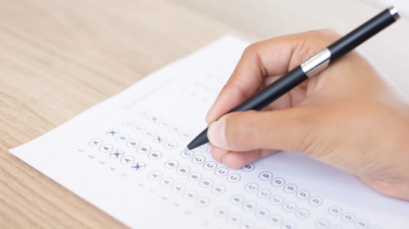 Ilustrasi peserta mengerjakan psikotes di atas kertas dengan posisi konsisten tanpa membalik kertas selama tes berlangsung