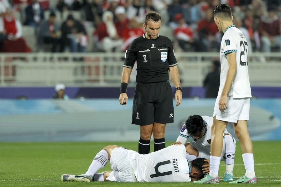 Bek timnas Indonesia #04 Jordi Amat terbaring di lapangan setelah mengalami cedera usai wajahnya disikut pemain Vietnam dalam pertandingan kedua Grup D Piala Asia 2023 antara Vietnam vs Timnas Indonesia di Stadion Abdullah bin Khalifa di Doha pada 19 Januari 2024.KARIM JAAFAR / AFP.