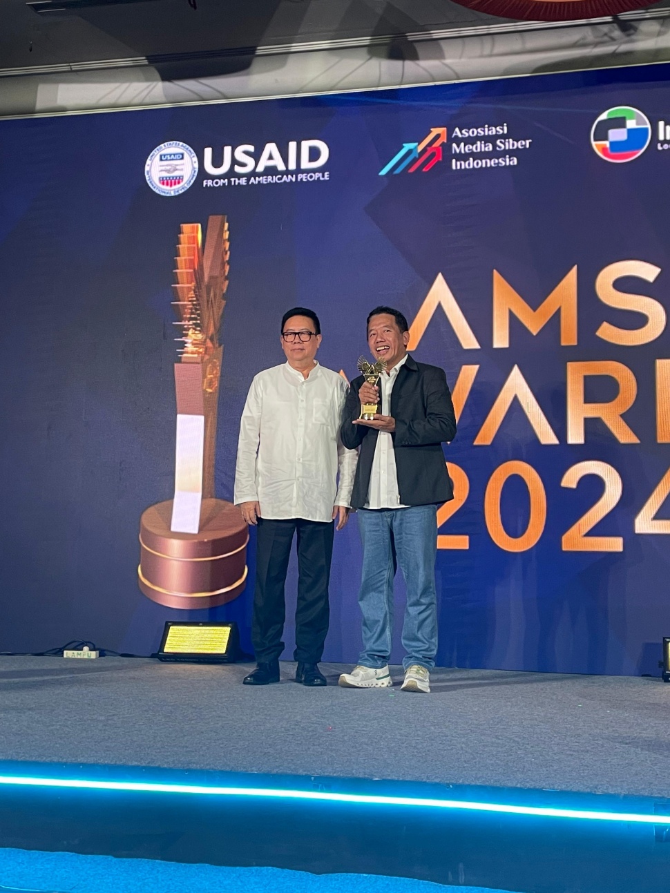 Pemred Suara.com Suwarjono dan Majelis Kehormatan AMSI Yosep Adi Prasetyo saat penyerahan penghargaan AMSI Awards 2024.(Dokumentasi Pribadi)