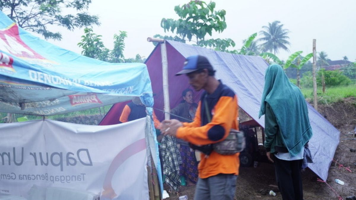 Warga di Desa Cieundeur, Warungkondang, Cianjur mendirikan tenda darurat di dekat rumahnya usai rumahnya ambruk diguncang gempa. [Foto: Zaki]