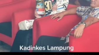 Viral Intip Wartawan Pakai Majalah saat Diperiksa KPK, Aksi Kadinkes Lampung Reihana Bikin Ngakak: Cilukba!