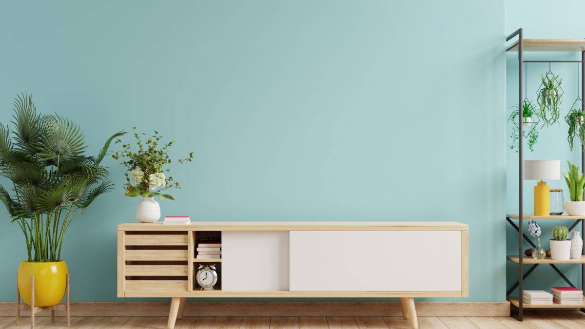 living-room-interior-with-cabinet-tv-empty-blue-wall-background-3d-rendering (1)