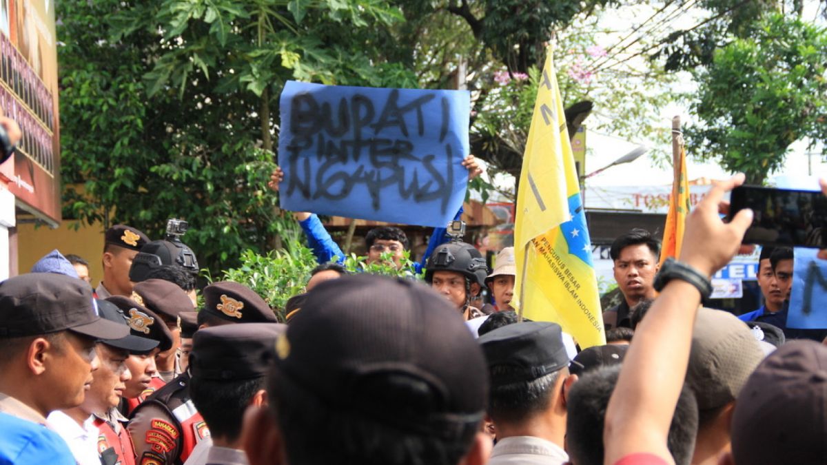 mahasiswa bentangkan spanduk saat orasi [ponorogo.suara.com/dedi.s]
