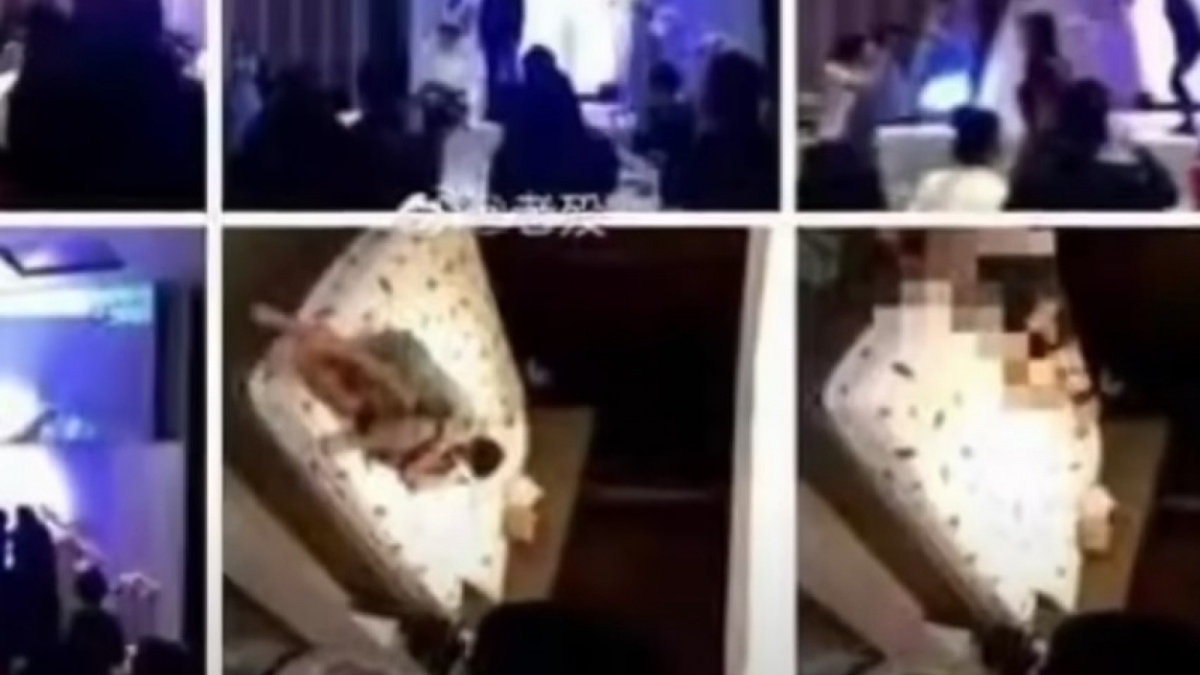 Tangkap layar video pengantin pria putar adegan ranjang mempelai wanita saat resepsi pernikahan. [Youtube drcact]